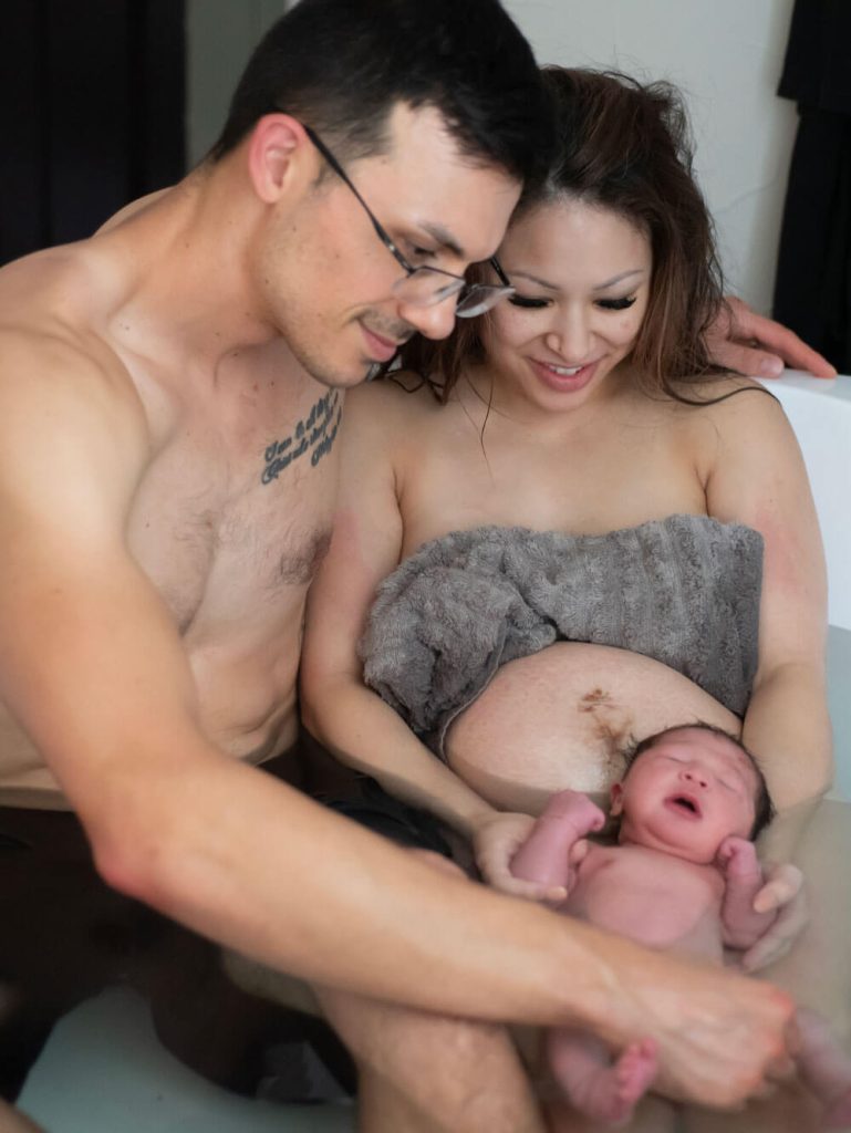 birth center natural birth texas midwife. photo of new family after waterbirth